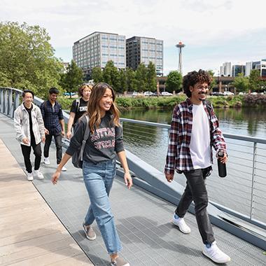 SPU students walk by the water with the Space Needle in the background | photo by Alex Garland